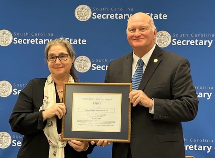 Joanne Goldblum receives an award from South Carolina Secretary of State Martin Hammond